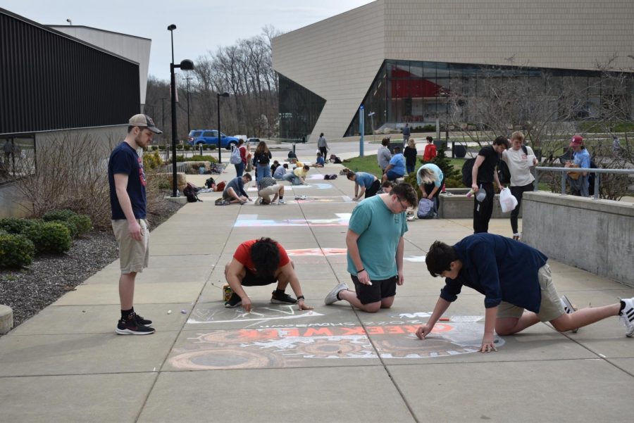Members of USIs Fraternity and Sorority Life gather together for a chalk mural competition during Greek Week 2022. Each sorority and fraternity created a chalk mural for the Greek Week 2022 Showdown.