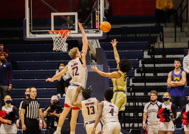 Jacob Polakovich, junior forward, achieves a huge block to send the ball into the student section.