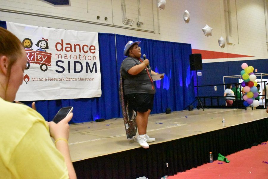 Hairo Rivas, co-president of Southern Indiana Dance Marathon, announces that dance participants should text someone they know to donate to help meet the goal of $50,000 on Saturday afternoon.