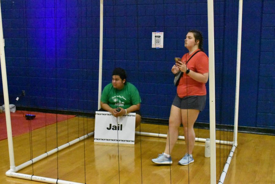 Eduardo Mejia, junior political science major, and Brylee Blackwell, freshman biology major, sit in jail while waiting on donations to release them.