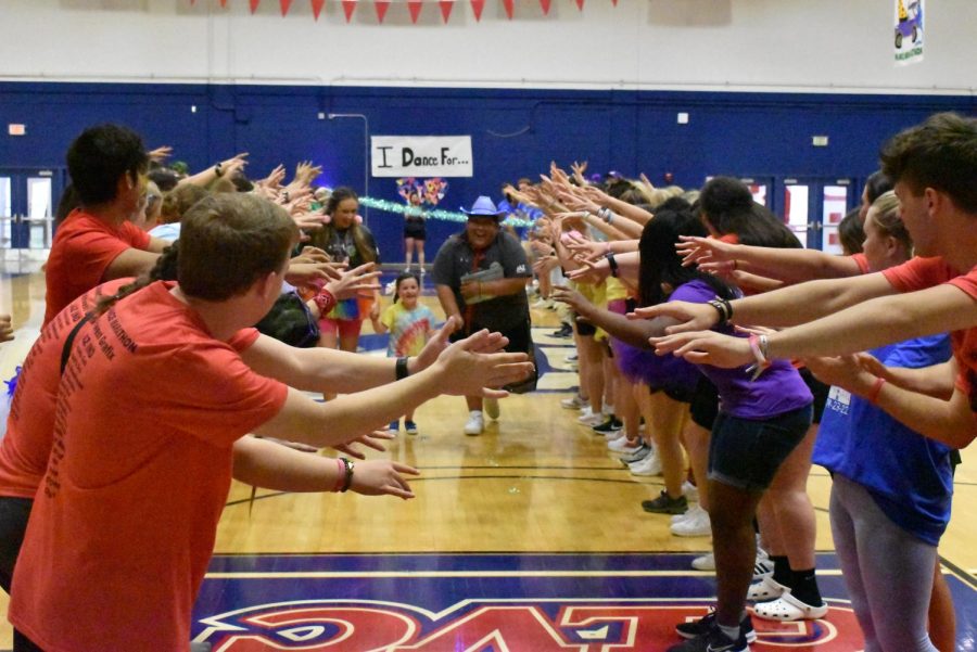 Southern Indiana Dance Marathon participants create a tunnel for children to run through at the Southern Indiana Dance Marathon Saturday afternoon.