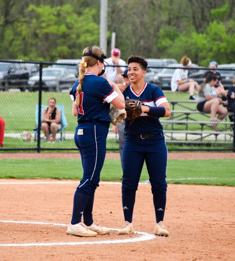 Mary Bean, senior third base and catcher, congratulates Newman after a strikeout on Sunday.
