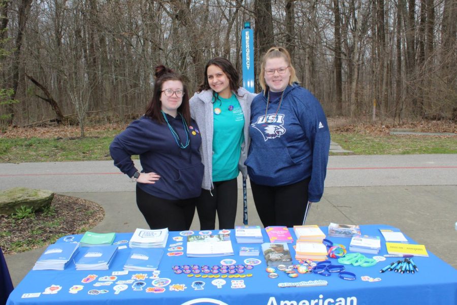 Brianna Aldana, junior geology major, Madison Gerbig, junior biology major, and Kaitlyn Yurchiack, junior psychology major, smile for a photo. The table they were running had many pamphlets with helpful information for those who may be struggling with depression or for those who have lost a loved one to suicide. They also had stickers, bracelets and pens to spread awareness and support the cause.