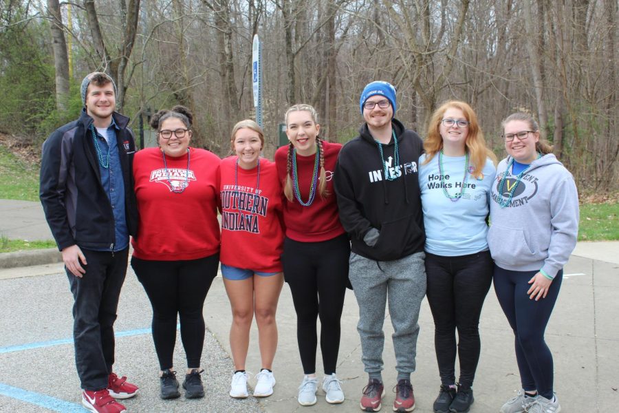 A group of students gather for a photo at the Out of the Darkness Stop Suicide Walk on Saturday. They all wear beads to show their support of ending suicide.