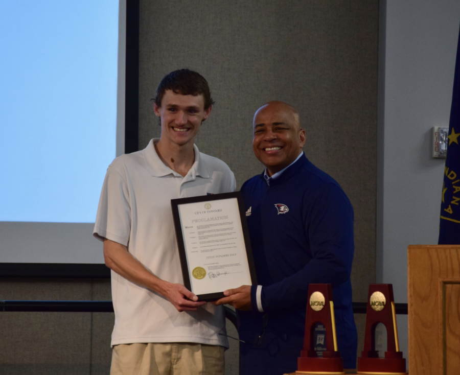 Titus Winders, junior sports management major, and President Ronald Rochon smile in Carter Hall after March 18, 2022, was named Titus Winders Day by Evansville Mayor Lloyd Winnecke. Winders became the first NCAA DII athlete to win two NCAA DII championships in an indoor track and field season March 12, 2022.