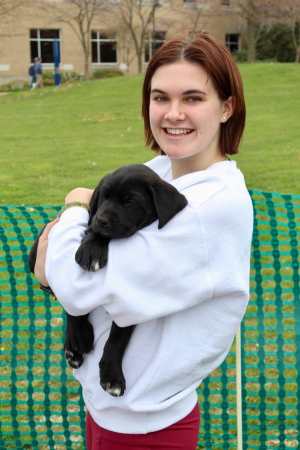Lexi Carmack, freshman biochemistry major, smiles while holding one of the puppies. The puppies were well taken care of during the event, food and water readily available and lots of people to love on them. The Pet-A-Pup event was held on Wednesday from 9 to 3 on the Quad.