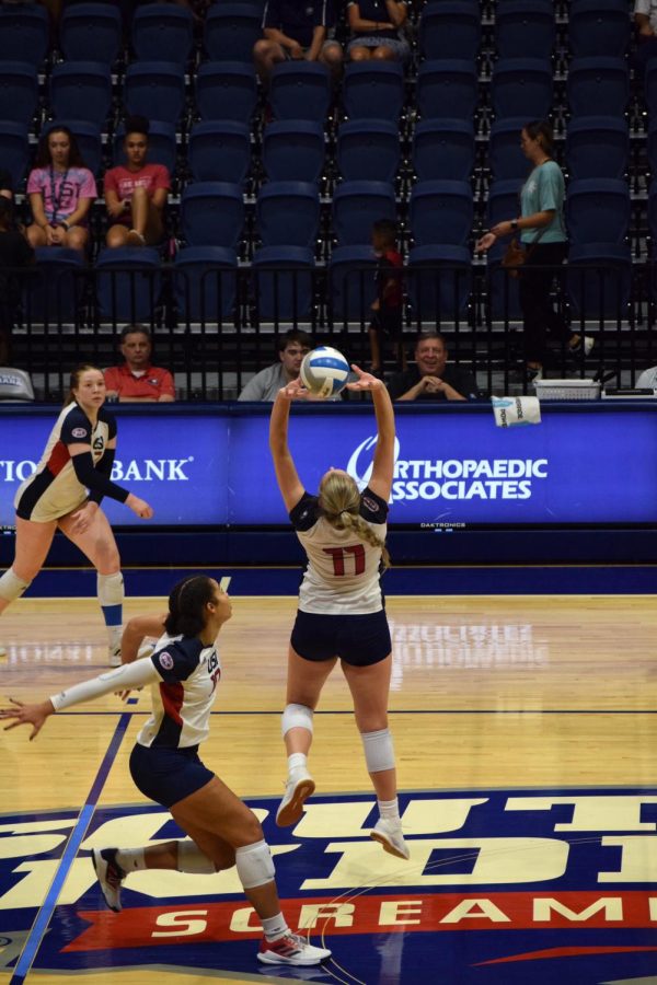 Katherine Koch, junior outside hitter, right side hitter and setter, sets the ball to Lauren ONeil, sophomore middle blocker, for a quick point in the game against Murray State University Friday.