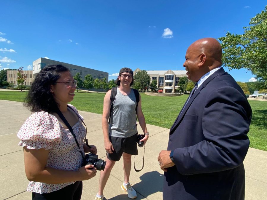President Ronald Rochon talks about the importance of student engagement to Crystal Killian, staff photographer, and Quinton Watt, sports editor on the quad.