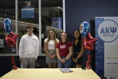 Jaeden O'Dell-Schultz, senior marketing major, Courtney Bourne, senior marketing major, Adrienne Betz, junior marketing major, and Christiana Wolfe, junior marketing major, advertise their organization, The American Marketing Association, in the Romain College of Business building on Aug 22. to recruit new students. AMA was formally USI Marketing Club before becoming an AMA chapter in Spring 2022. (Photo by Crystal Killian)