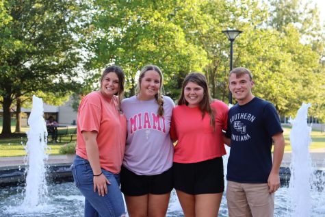 Maddy Shields, sophomore occupational therapy assistant and health administration major, Annie Tenbarge, freshman nursing major, Aubrey Ward, freshman pre-nusing major, and Marcus Robinson, sophomore pre-nusing major, smile together in front of the University Center Fountain. (Photo by Tegan Ruhl)
