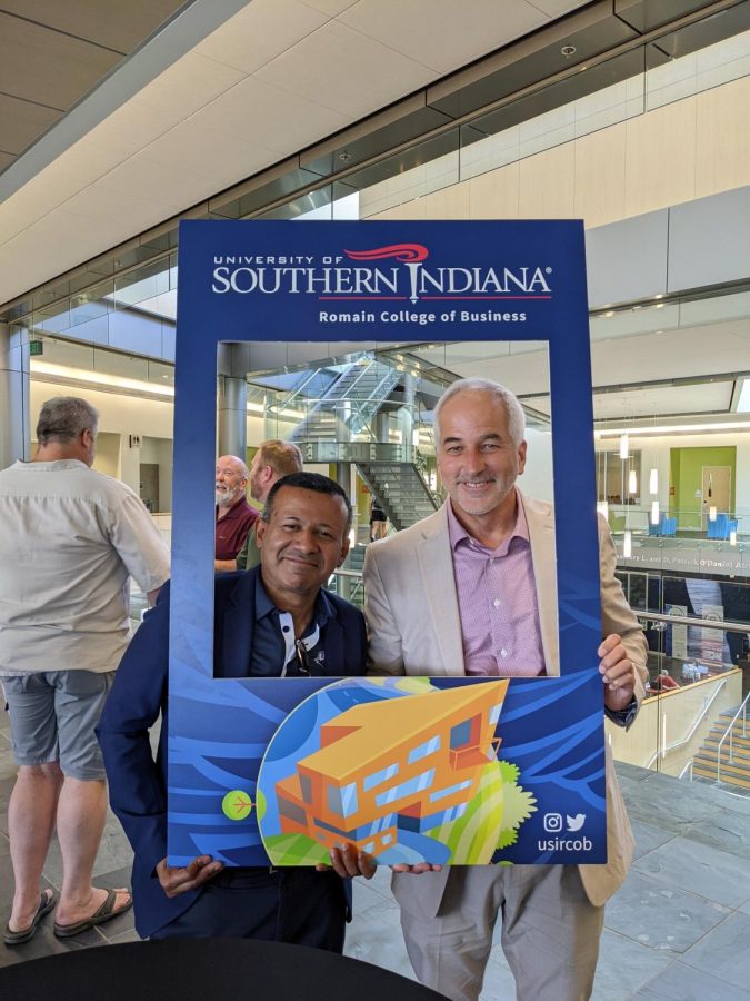 Sudesh Mujumdar (left) and Del Doughty (right) present themselves in a picture frame. Doughty stopped by to meet Mujumdar during the Romain College of Business Meet the Dean Aug. 24.