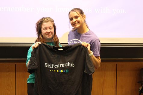 Brianna Aldana, president of Active Minds, and Madison Gerbig, vice president of Active Minds, hold a 'Self care club' shirt in Kleymeyer Hall. Active Minds hosted their annual National Suicide Prevention Month Memory Walk Saturday. (Photo by Bryce West)