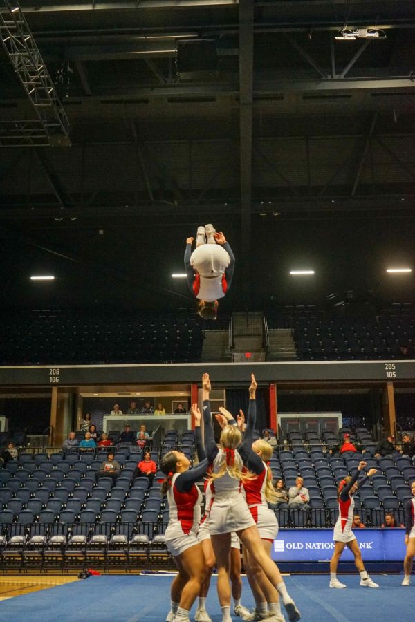 The cheer team performs a stunt at the 2022 Midnight Madness event Thursday in the Screaming Eagles Arena. The team put on a dance performance to start the event.