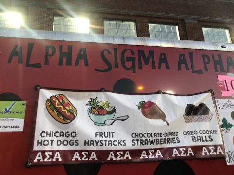 he Alpha Sigma Alpha Booth 104 at the Fall Festival on Franklin Street Tuesday. The booth offered Chicago hot dogs, fruit haystacks, chocolate-dipped strawberries and Oreo cookie balls. (Photo by Alyssa DeWig)