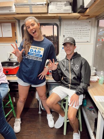 Lane St. Clair and Jackson Springer flash the Young Life hand sign, which is a 'Y' and an 'L' for 'Young Life.' The two sat in the booth to help and prepare for the Fall Festival. (Photo courtesy of Raychel Guiser)