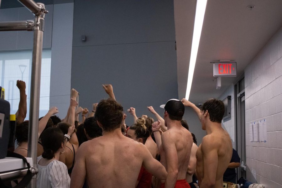 USIs swimming and diving team cheers at the end of their meet in the Aquatic Center Saturday.