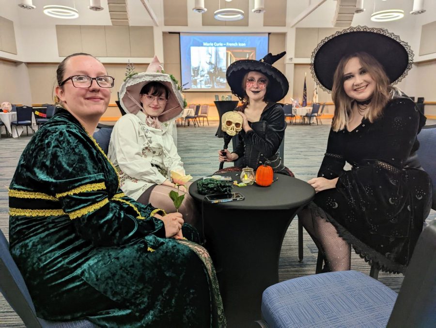 Cassidy Luecke, sophomore special education major, Rebecca Olsen, sophomore business administration major, Asher Bulleit, junior psychology major, and Elizabeth Bryant, sophomore German education major, socialize at the You Know Who! costume event hosted by the World Languages and Cultures department Wednesday in Carter Hall. (Photo by Crystal Killian)