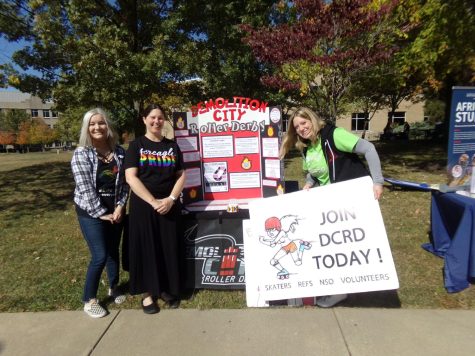 Demolition City Roller Derby members smile in front of their organization's table. Their table was one of many participating in PrideFest on The Quad Friday. (Photo by Alyssa DeWig)