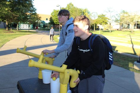 Jacob Angermeier, freshman engineering major, and Blake Baumgart, freshman business administration major, play a shooting game at the Activities Programming Board's annual Fall Bash on The Quad Thursday. (Photo by Bryce West)