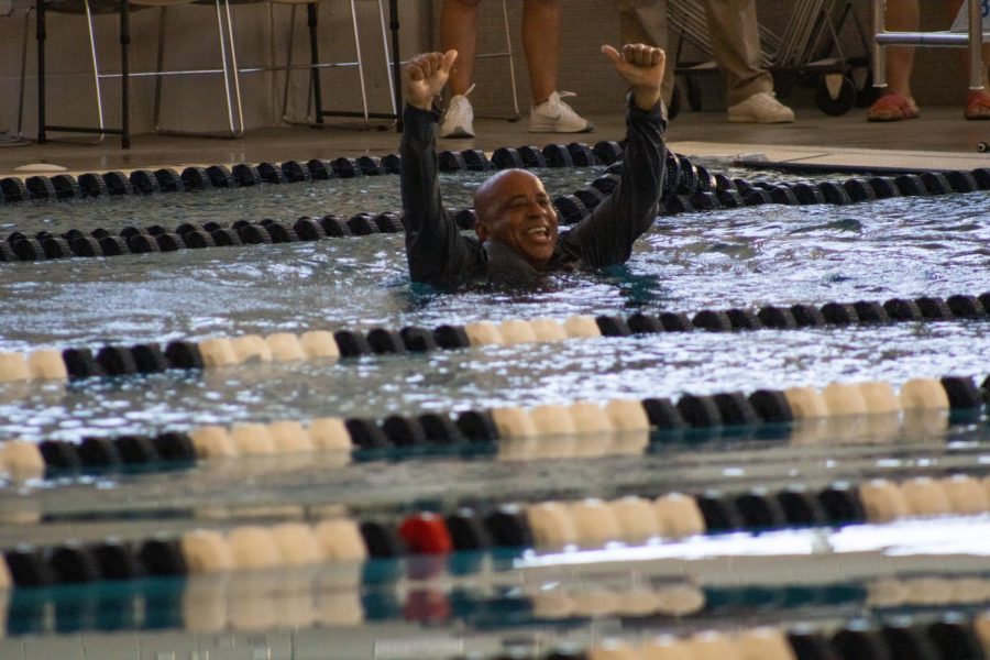 President Ronald Rochon smiles inside the pool after he jumped in at the Aquatic Center Saturday. Rochon dove in to surprise everyone for the first swim meet.