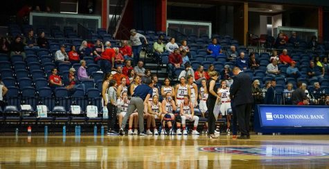 The womens basketball team rests during a media timeout against Oakland City University Nov. 7 in the Screaming Eagles Arena. (Photo by Quinton Watt)
