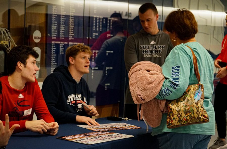Jacob Polakovich, senior forward, signs an autograph for a fan during the meet-and-greet Friday in the Screaming Eagles Arena.