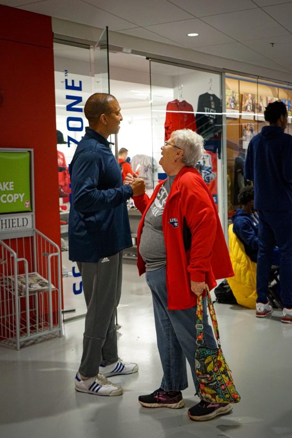 Chris Moore, mens assistant basketball coach, greets a fan during the meet-and-greet Friday in the Screaming Eagles Arena.