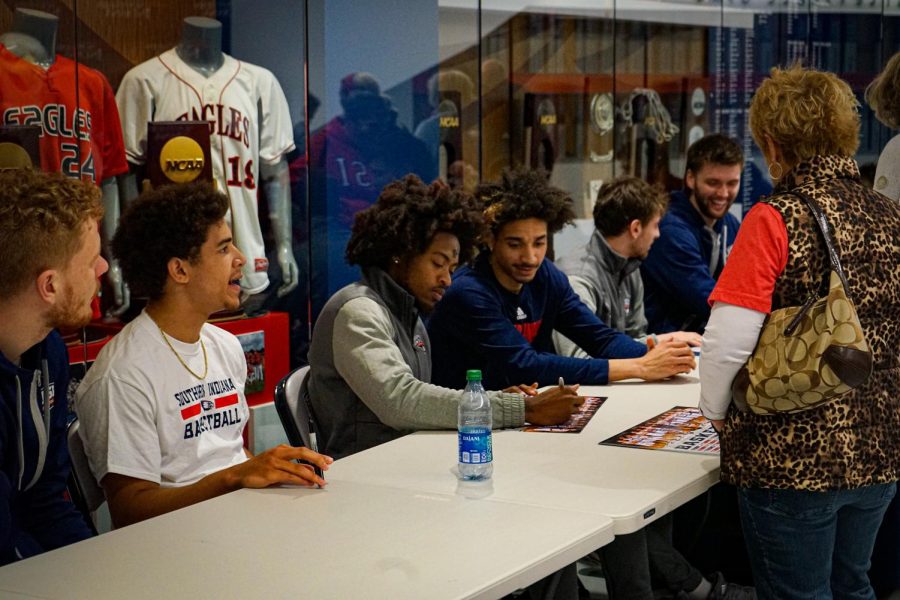 The mens basketball team sign autographs for fans during the mens meet-and-greet Friday in Screaming Eagles Arena.