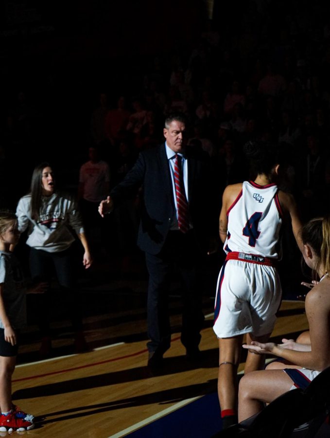 Head coach Rick Stein greets the womens basketball team as they are announced at the game against Western Illinois University Friday in the Screaming Eagles Arena.