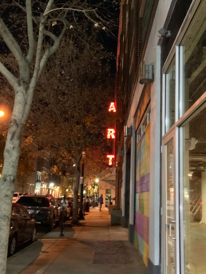 A street in Cincinnati is well-lit at night as Art Club members explore during their trip Friday. 