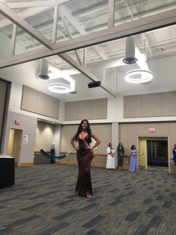 Maria Lopez, sophomore engineering major, smiles as she faces the audience of the PANAS Connection event Thursday in Carter Hall. Lopez was the 2021-2022 University Center East queen. (Photo by Alyssa DeWig)