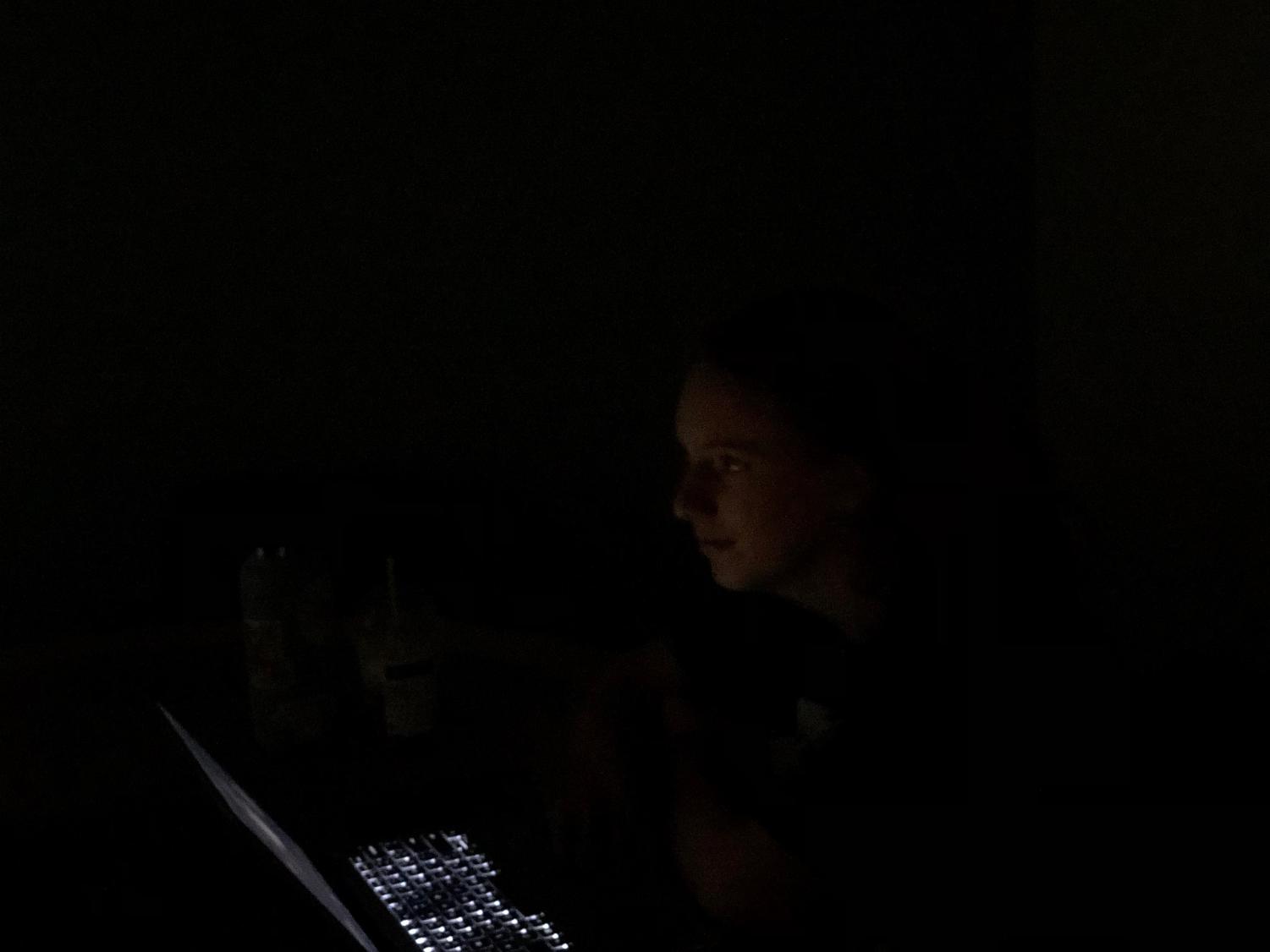 Bethany Wilson, freshman nursing major, sits in complete darkness in one the study rooms of the David L. Rice Library around 4 p.m. Thursday. 