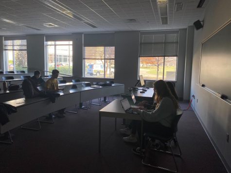 Students work on their PHIL 201 group final project in an empty classroom on the first floor of the Liberal Arts building around 2:30 p.m. Monday. Campus experienced a power outage around 1 p.m. Monday, the first official day of finals.