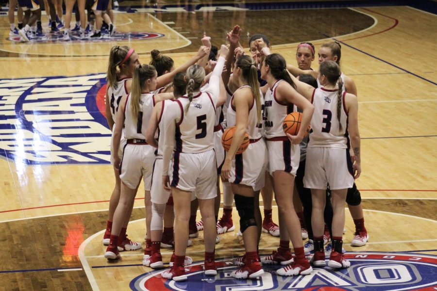 The womens basketball team huddle together at the womens basketball game Saturday in the Screaming Eagles Arena.