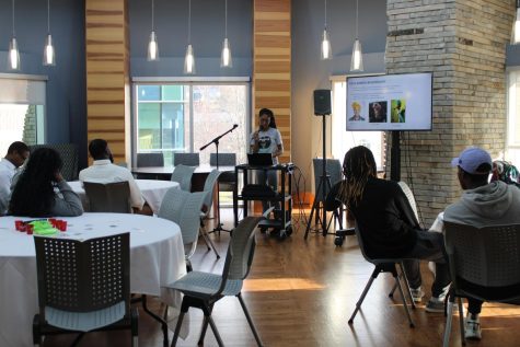 Kenecia Hawley, president of Authentically Me, gives a presentation on the history of headwraps Monday at Authentically Me's "Rock the Wrap" seminar in the Traditions Lounge. (Photo by Bryce West)