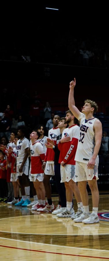 Jacob Polakovich, senior forward, prays and points at the sky in honor of his late father at the mens basketball game Saturday in the Screaming Eagles Arena.