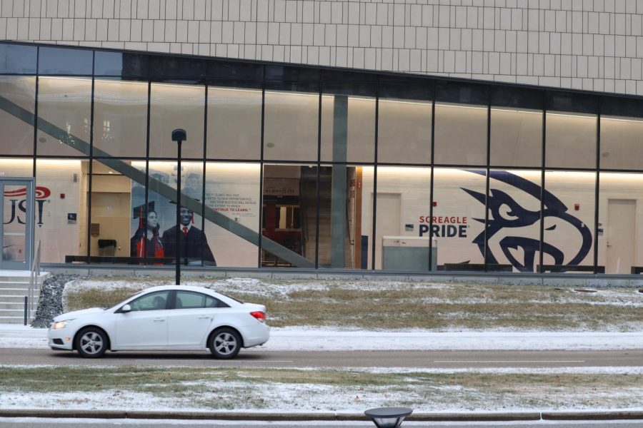 A car drives past the Screaming Eagles Arena Tuesday. There were still patches of ice on the road and in the university parking lots. (Photo by Ian Young)