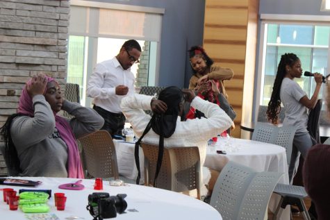 Students put on headwraps Monday at Authentically Me's "Rock the Wrap" headwrap seminar in the Traditions Lounge. (Photo by Bryce West)