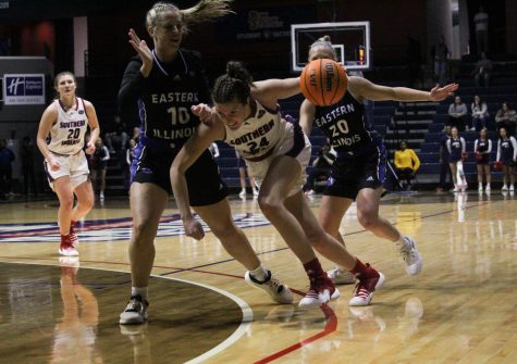 Tara Robbe, senior forward, charges past Eastern Illinois University players at the womens basketball game Thursday in the Screaming Eagles Arena.