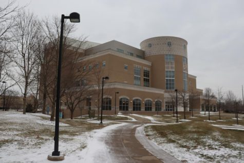 A thin layer of snow and solid ice is visible on the lawn of the David L. Rice Library Tuesday. (Photo by Ian Young)