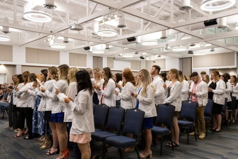 Nursing students recite the White Coat Ceremony Oath in Carter Hall Sept. 11. With this oath, the students pledged to accept the duties of the nursing profession and provide high quality care. (Photo by Crystal Killian)
