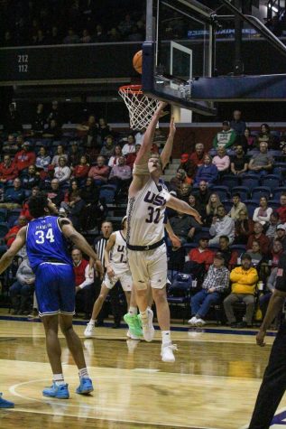 Jacob Polakovich, senior forward, goes for a layup at the men's basketball game Thursday in the Screaming Eagles Arena.