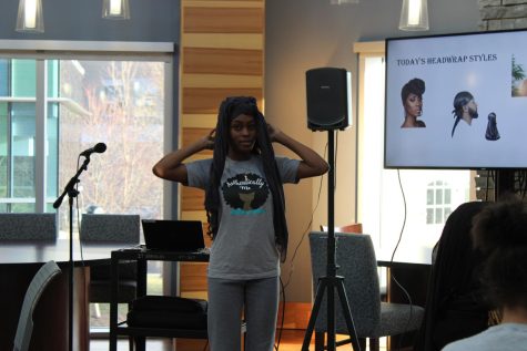 Kenecia Hawley, president of Authentically Me, demonstrates how to put on a headwrap Monday at Authentically Me's "Rock the Wrap" seminar in the Traditions Lounge. (Photo by Bryce West)