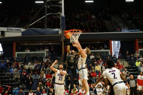 Jacob Polakovich, senior forward, blocks a shot from Morehead State University Feb. 4 in the Screaming Eagles Arena.