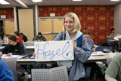 Hazel Mans, sophomore business administration major, shows off her finished design at the Neon Signs event Thursday in University Center East (Photo by Crystal Killian).