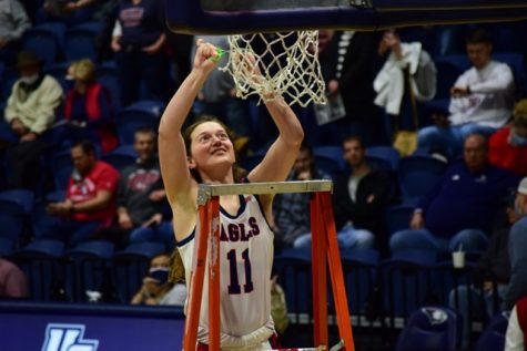 Soffia Rieckers, senior guard, cuts down her piece of the net after the GLVC title win against Lindenwood University Feb. 26, 2022 in the Screaming Eagles Arena.