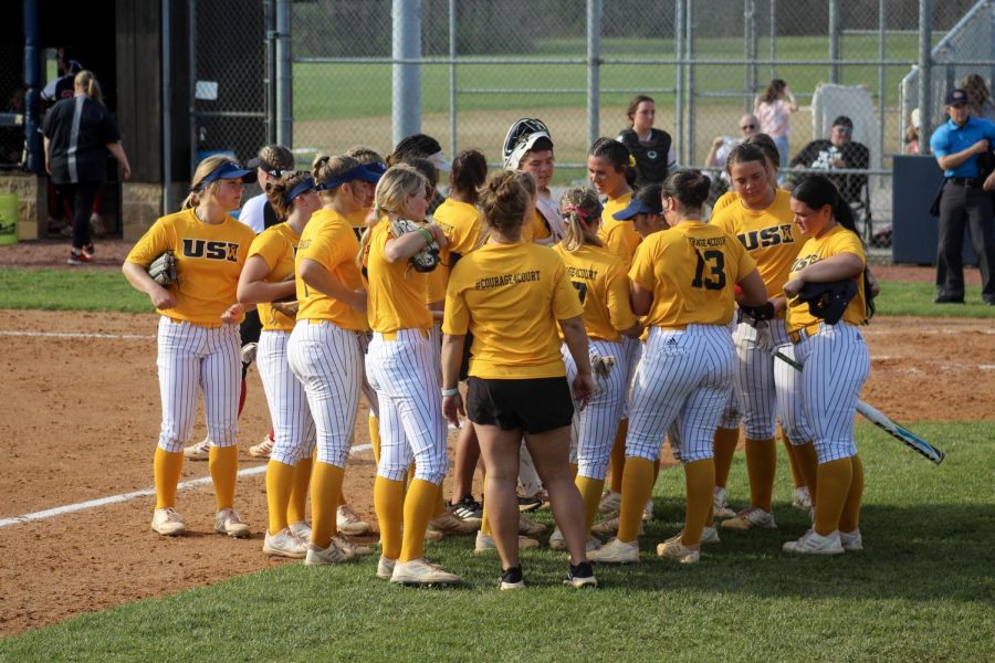 The womens softball team gathers together before going onto the field Tuesday in the game against Indiana University-Purdue University Indianapolis at the USI Softball Field.