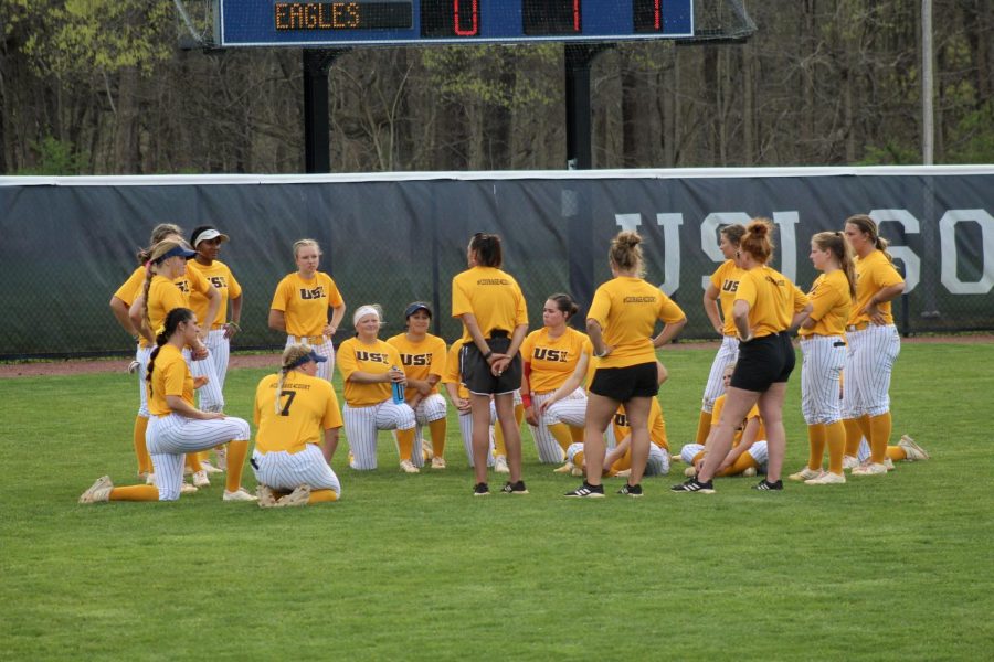 The womens softball team meets in the outfield Tuesday after the game against Indiana University-Purdue University Indianapolis at the USI Softball Field.