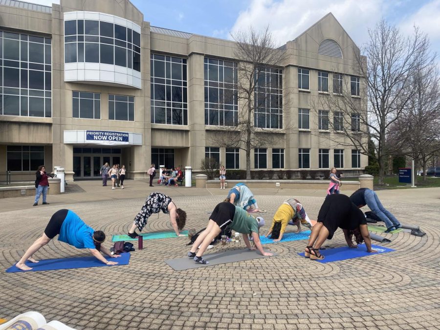 Students and faculty do yoga outside the Liberal Arts Center on the Labyrinth Tuesday.