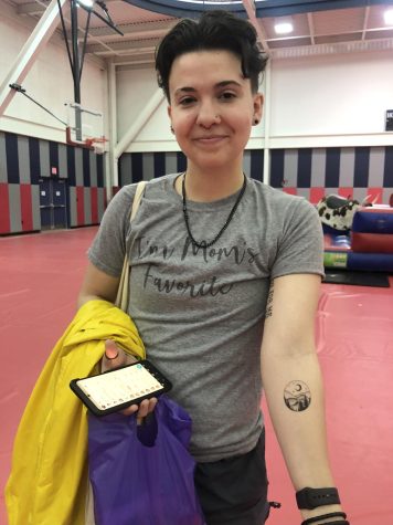 Kye Klemczewski, sophomore pre-social major, shows off their temporary tattoo at Condom Carnival Wednesday in the Recreation, Fitness and Wellness Center. (Photo by Alyssa DeWig)